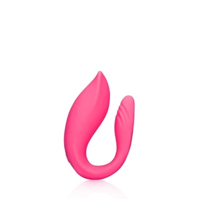 Dispositivo de silicone cor-de-rosa ergonómico curvo contra fundo branco