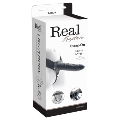 Embalagem branca de strap-on Real Rapture com dildo preto realista e arnês ajustável.