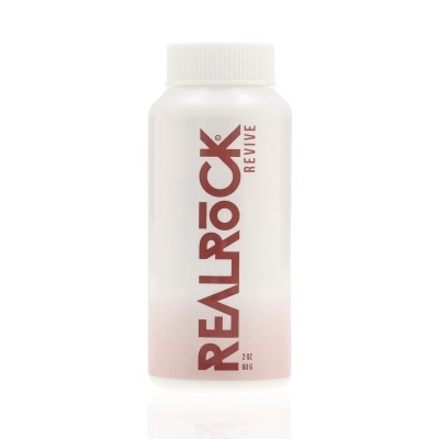 Frasco branco com tampa e texto vermelho vertical REAL ROCK REVIVE