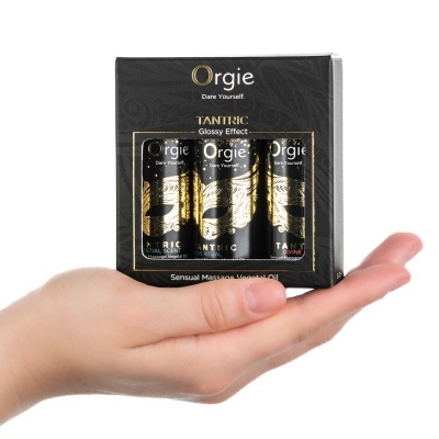 Conjunto de óleos de massagem Orgie Tantric em embalagem preta com letras douradas e máscara dourada