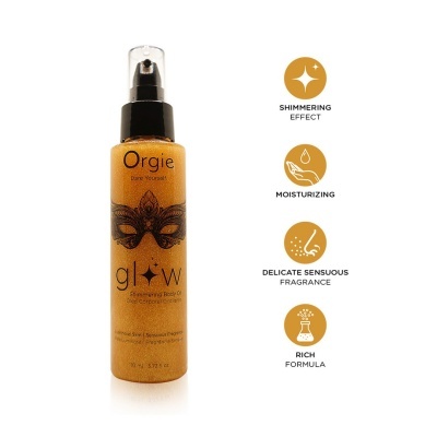 Frasco dourado de spray corporal iluminador Orgie com etiqueta preta e máscara veneziana