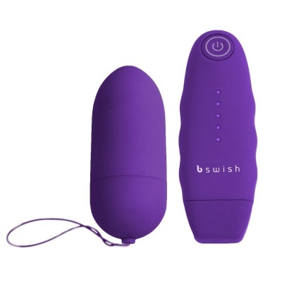 Dispositivo elétrico roxo em forma de cápsula com controlo remoto roxo
