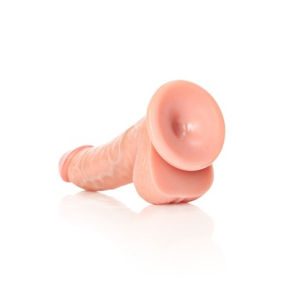 Dildo cor da pele com textura veiculada e base oval sobre fundo branco