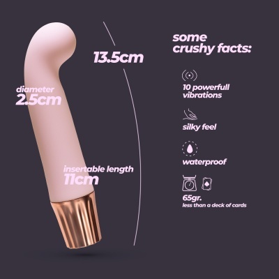 Vibrador cor de pele clara com base metálica dourada e texto descritivo das suas características.