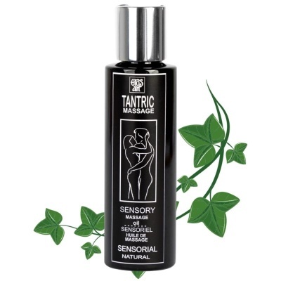 Frasco preto de óleo para massagem tátil com desenho de casal, texto em inglês e francês e folhas verdes ao fundo