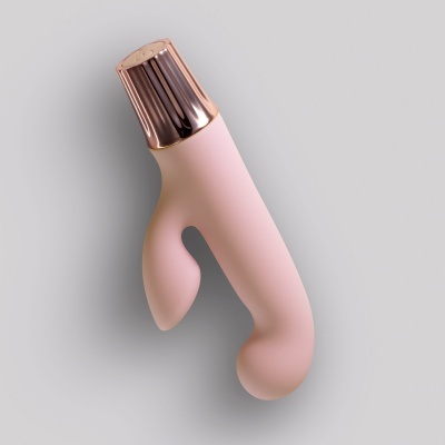 Objeto cor-de-rosa com tampa metálica rose gold sobre fundo cinzento