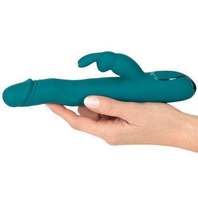 Vibrador verde azulada em silicone segurado numa mão