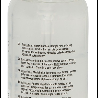 Frasco de gel lubrificante médico transparente com tampa branca e texto multilíngue no rótulo