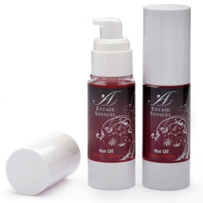 Frascos de óleo quente Extase Sensuel com rótulo vermelho e tampa branca.