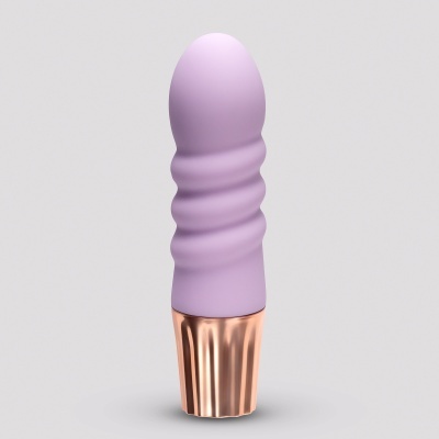 Produto lilás com base dourada rose em fundo cinzento