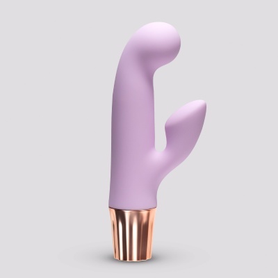 Vibrador lilás em silicone com base dourada, fundo cinza