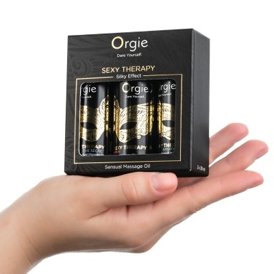 Caixa de óleo de massagem sensual Orgie Sexy Therapy com três frascos embalados e design de máscara dourada