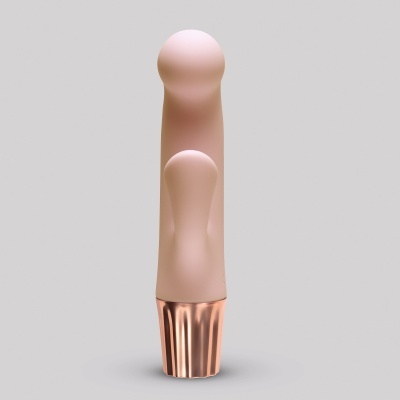 Vibrador rosa com base metálica cor de cobre em fundo cinzento