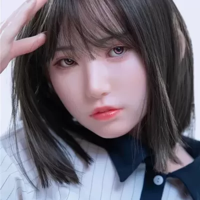 Boneca realista com cabelo castanho e camisa branca às riscas