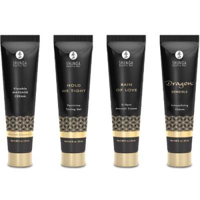 Quatro tubos pretos de creme Shunga com tampas douradas alinhados em fundo branco.