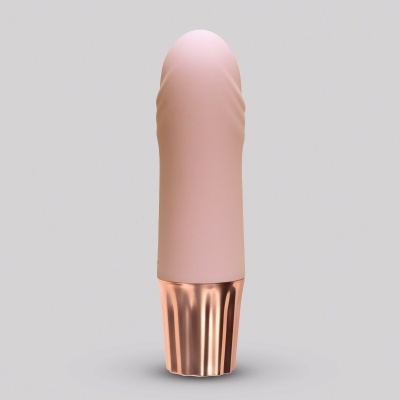 produto compacto com tampa rosa claro e base metálica cobre