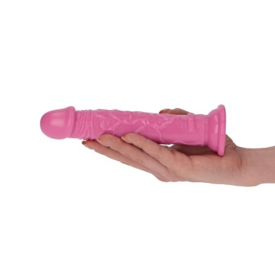 Dildo rosa com textura veiculada segurado por uma mão