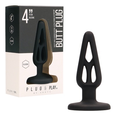 Plug anal preto em silicone junto com sua embalagem preta e branca em fundo branco.