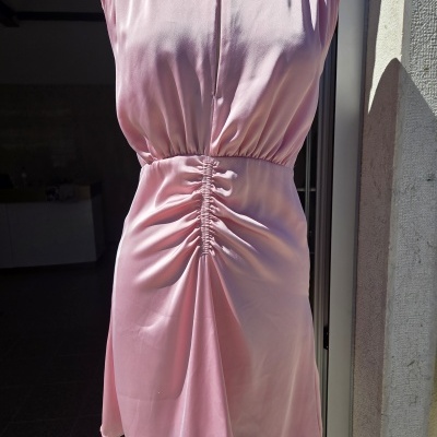 Vestido rosa claro com franzidos centrais nas costas em manequim