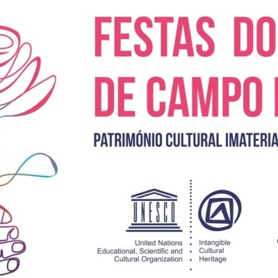 Ilustração de uma mão segurando uma flor colorida com texto sobre Festas do Povo de Campo Maior e logos da UNESCO e Campo Maior