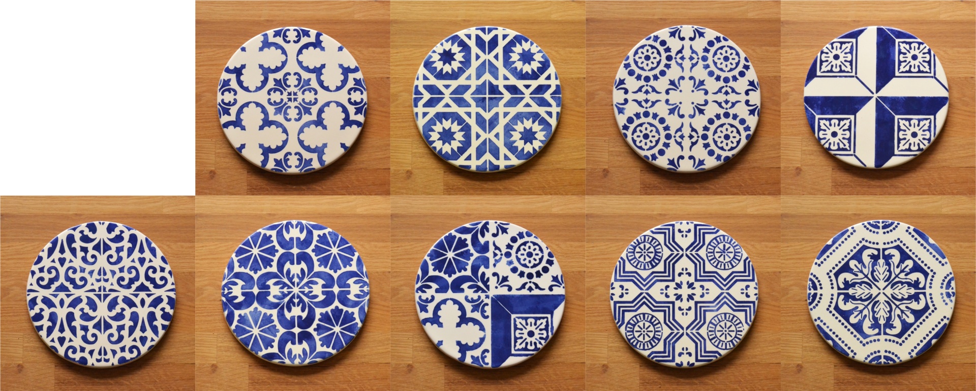 Round ceramic coasters with blue and white patterns on wooden surface