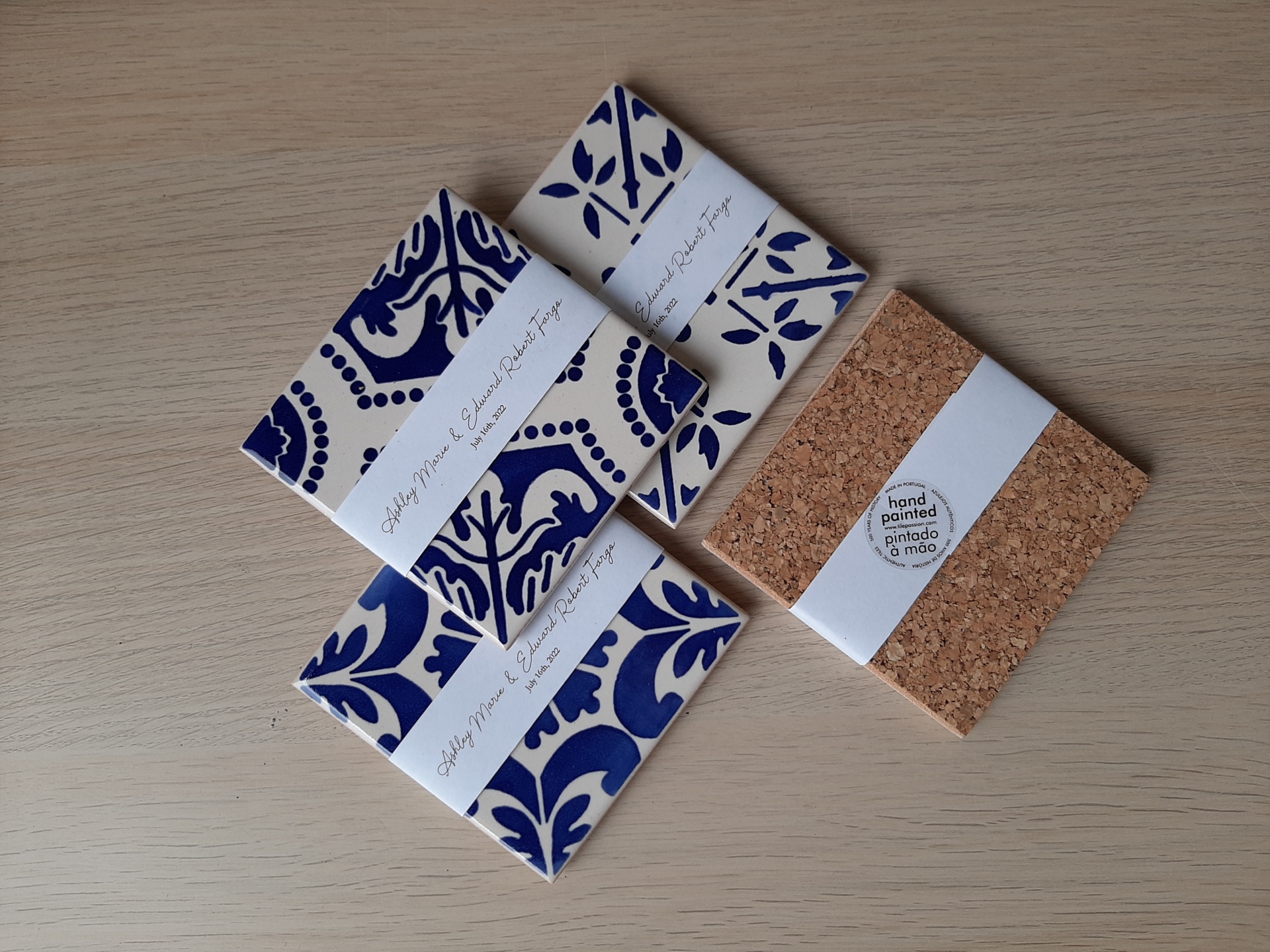 Hand-painted blue and white ceramic tiles with cork backing and personalized white paper bands