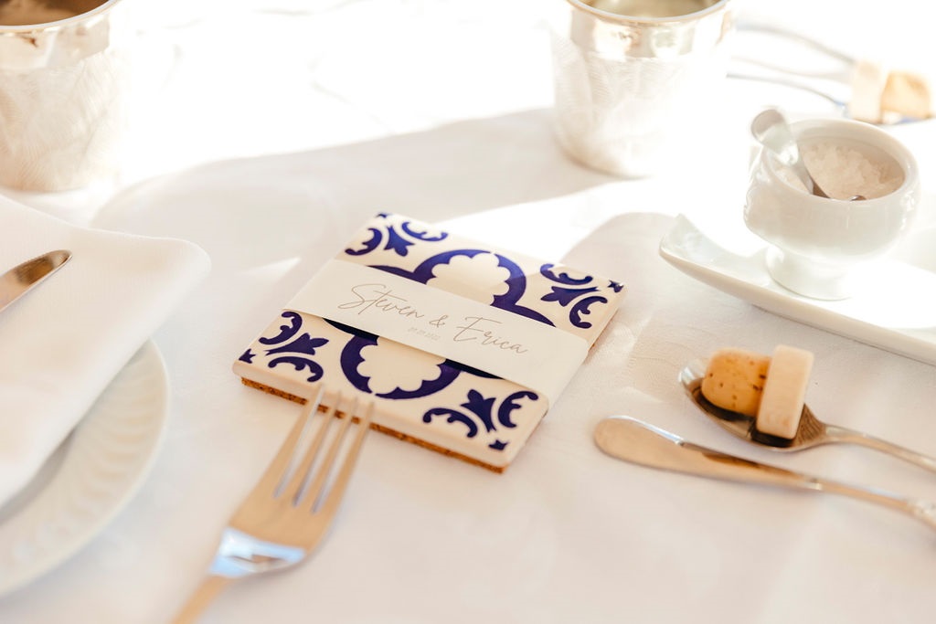 Ceramic coaster with blue and white pattern and names Steven & Erica on a white table setting