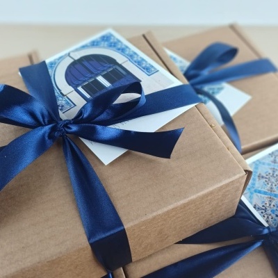 Brown gift boxes with blue satin ribbons and patterned cards