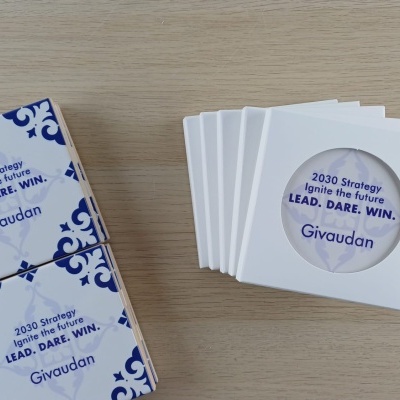 Square booklets with blue decorative patterns and white covers with circular cutouts displaying text