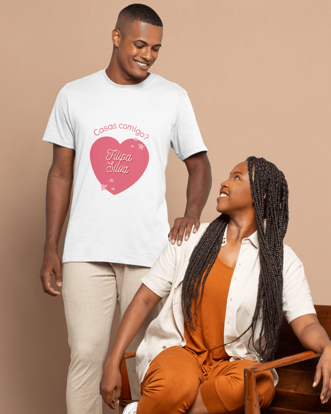 Homem com t-shirt branca estampada e mulher sentada à sua frente