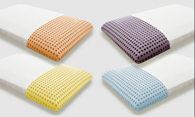 Quatro almofadas retangulares com extremidades coloridas e padrão de pontos grandes.