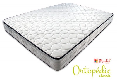 Colchão ortopédico branco com padrão hexagonal e acabamento escuro