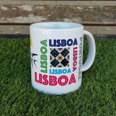Caneca branca com texto colorido Lisboa sobre relva artificial