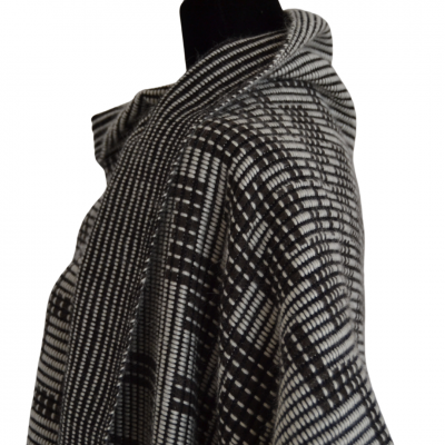 Xale preto e branco com padrão geométrico em manequim preto