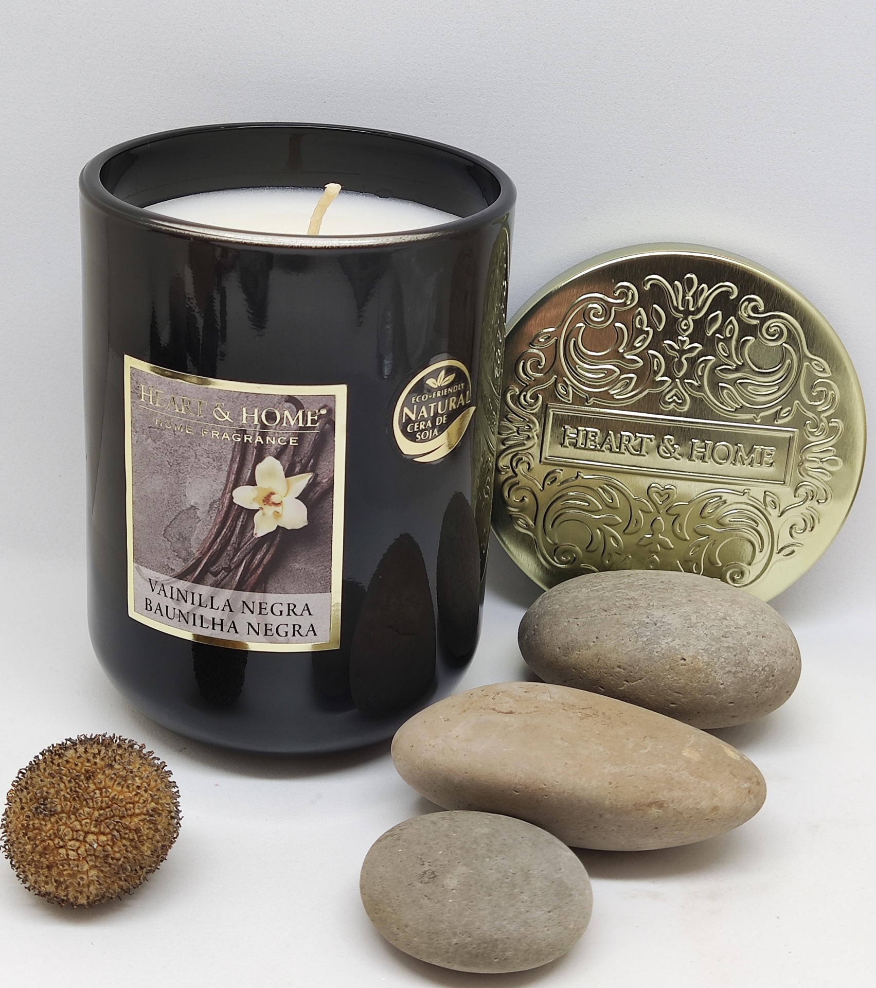 Vela perfumada preta com tampa dourada e pedras decorativas