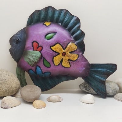 Peixe decorativo metálico roxo com flores coloridas e conchas ao redor