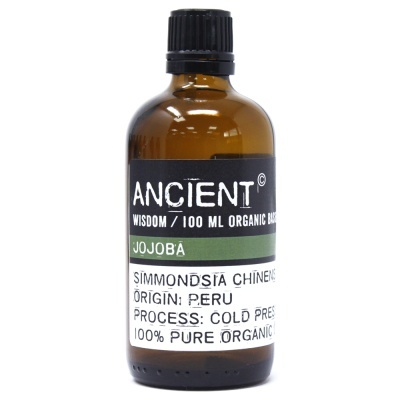 Frasco de vidro castanho de óleo de jojoba com etiqueta preta e branca