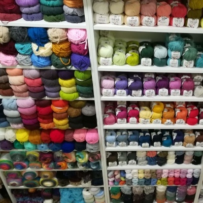 Novelos de lã coloridos organizados em prateleiras