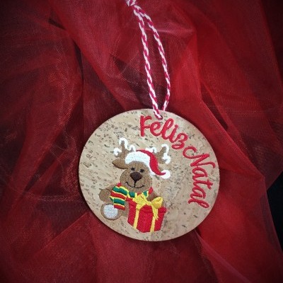 Etiqueta redonda de cortiça com rena, presente e texto Feliz Natal