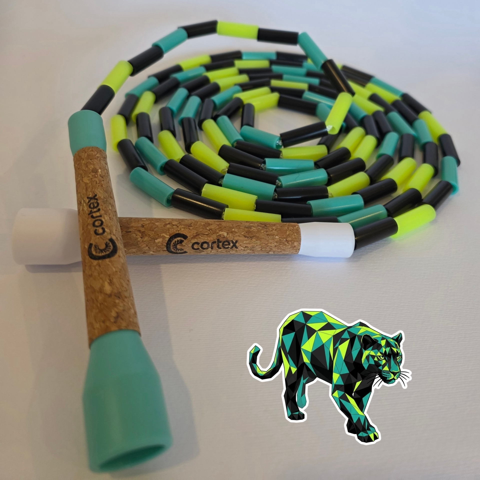 Beaded jump rope with cork handles and colorful beads on white surface with panther sticker