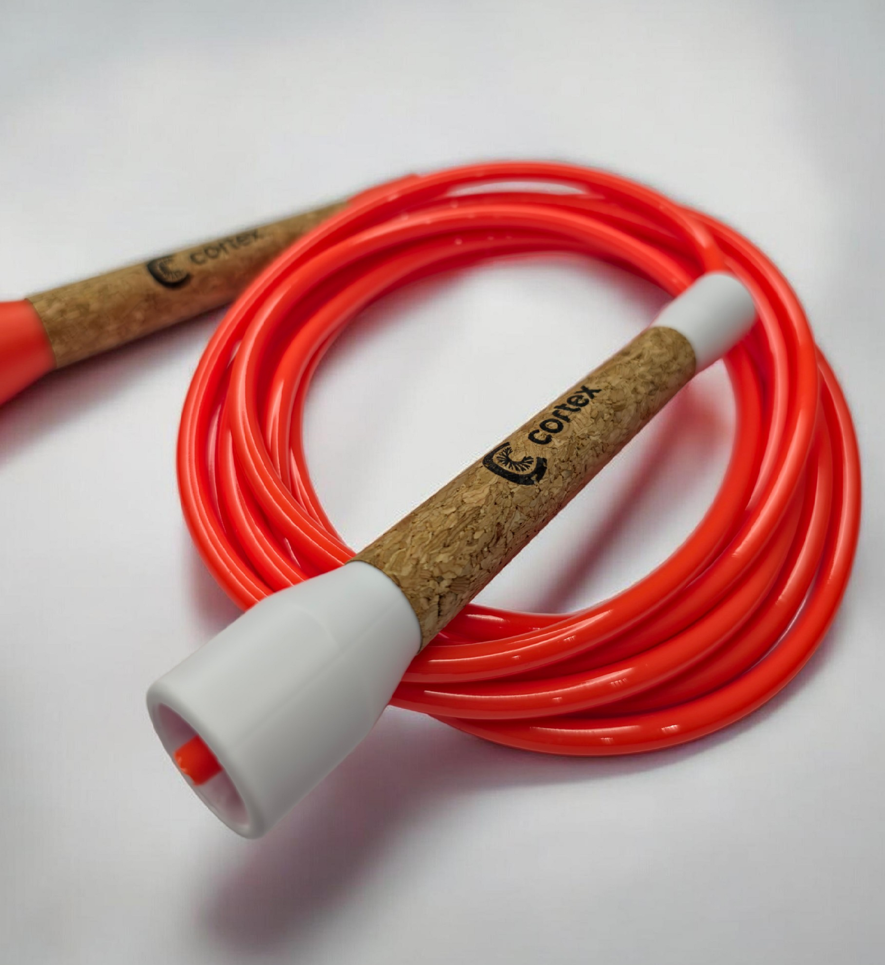 Orange skipping rope with cork handles and white plastic ends