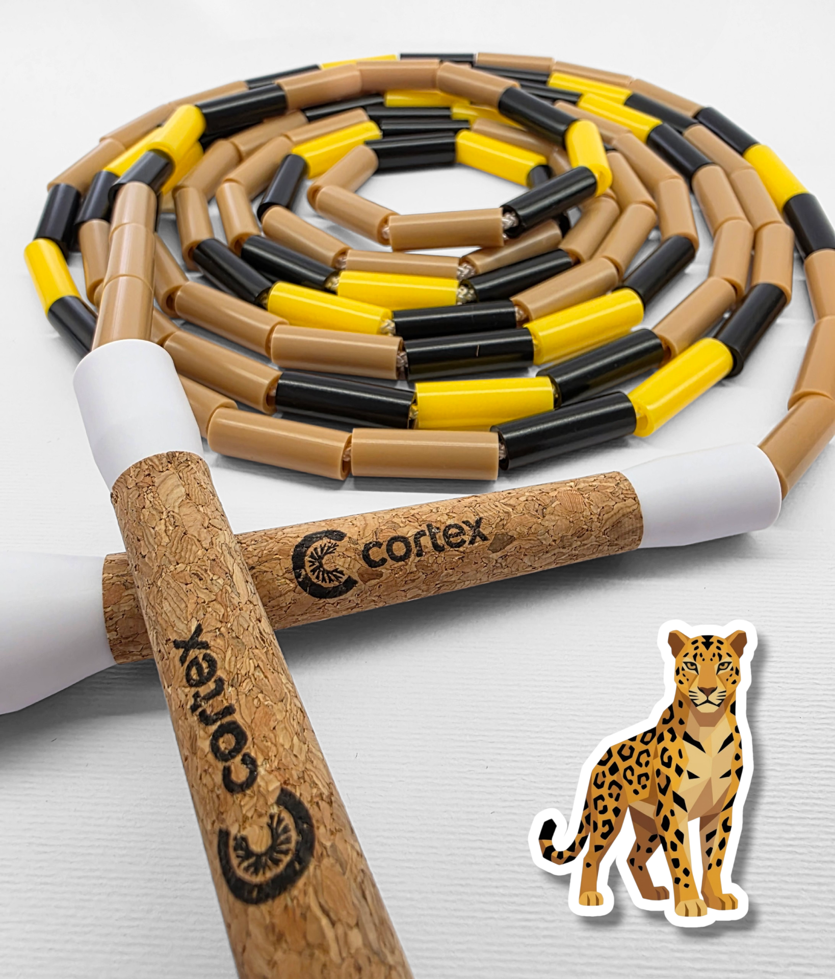 Jump rope with cork handles and brown, yellow, and black beaded rope on white background with leopard sticker