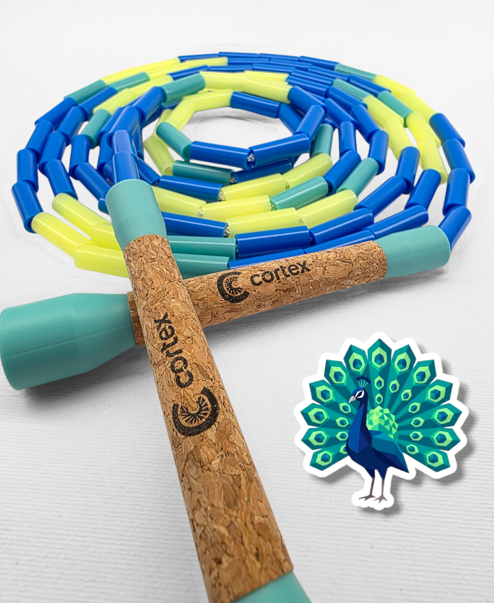 Jump rope with cork handles and blue, teal, yellow plastic beads with a peacock sticker