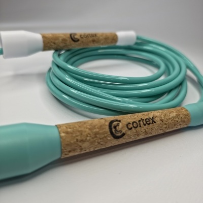 Turquoise jump rope with cork handles labeled cortex on white background