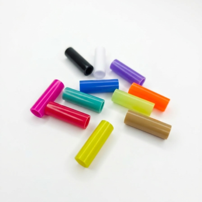 Colorful cylindrical plastic tubes on white background