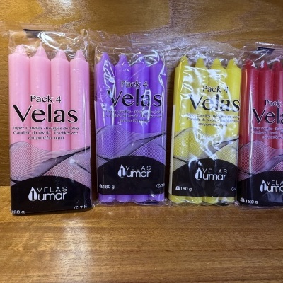 Pacotes de velas cónicas em plástico transparente, 4 unidades por embalagem, cores rosa, roxa, amarela e vermelha.
