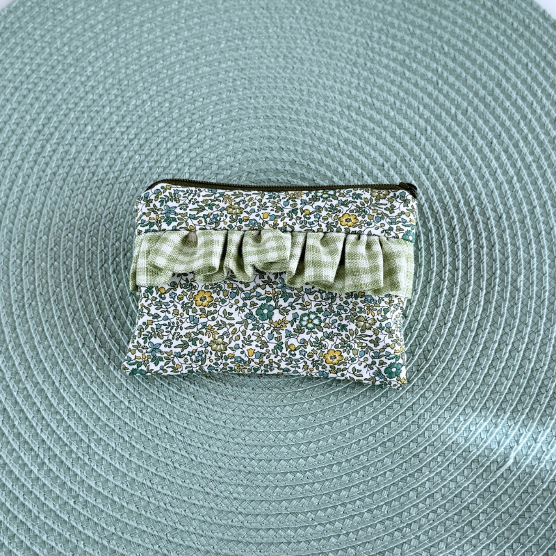 Bolsa pequena retangular em tecido com padrão floral e detalhe xadrez