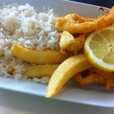 Prato com arroz branco, fritos e fatia de limão