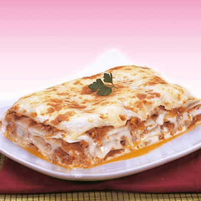 Lasagna servings with meat sauce and melted cheese on white plate