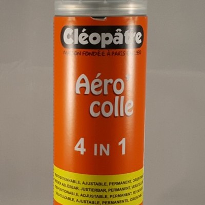 Lata de spray cola Cléopâtre laranja com tampa translúcida e figura feminina ilustrada